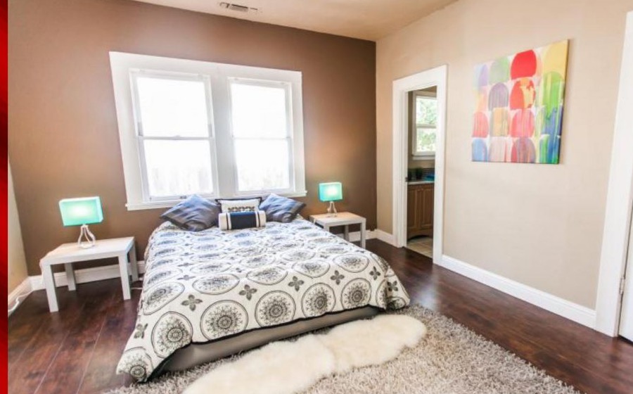 Finished bedroom with neutral tones and updated flooring