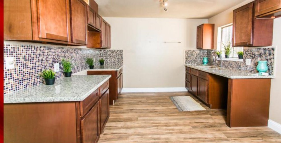 Granite kitchen with mosaic backsplash and staged decor