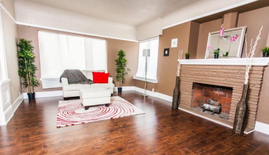 Staged living room with fireplace and polished floors